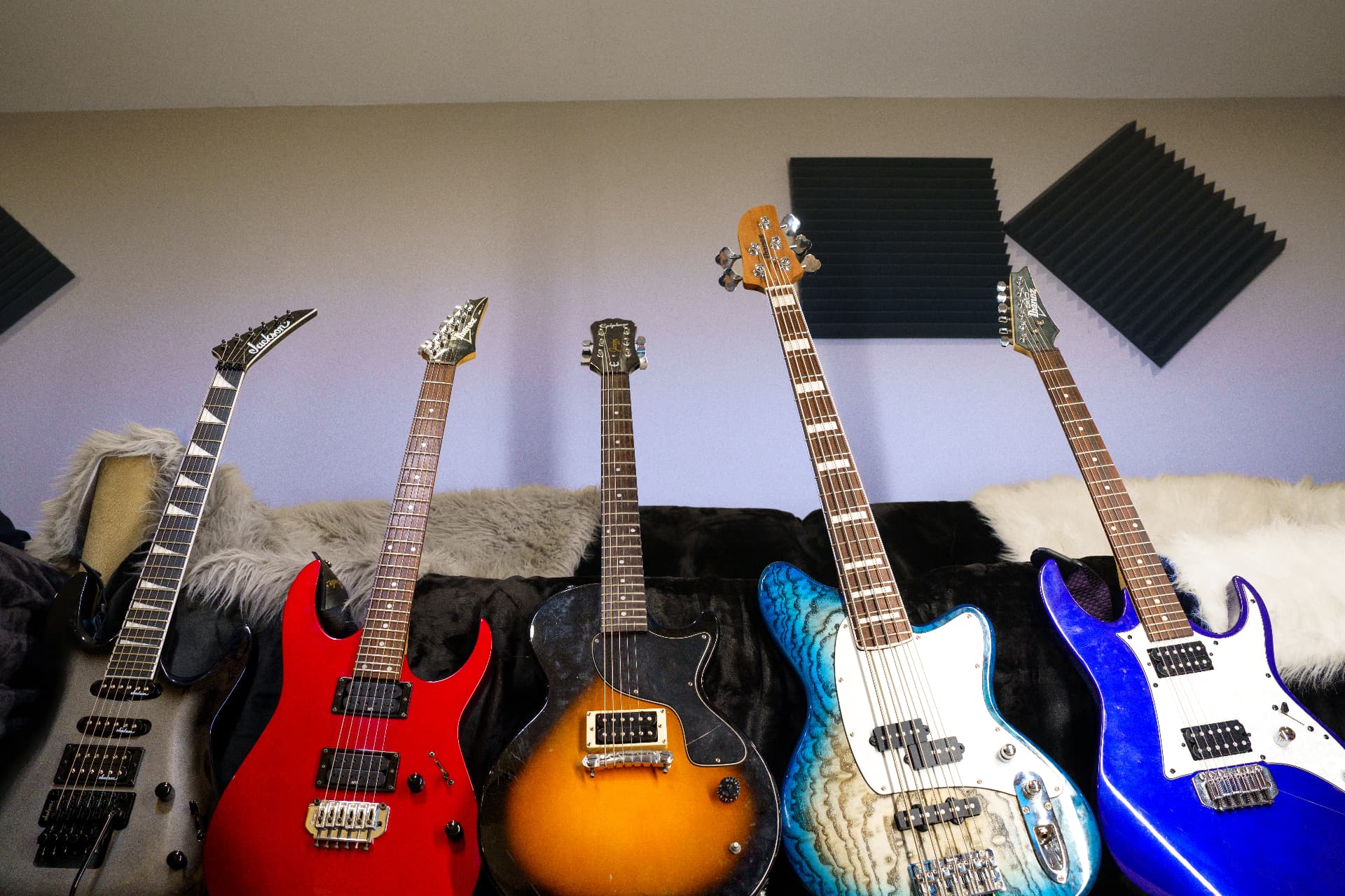 Collection of electric and bass guitars used for guitar lessons at Peace Academy