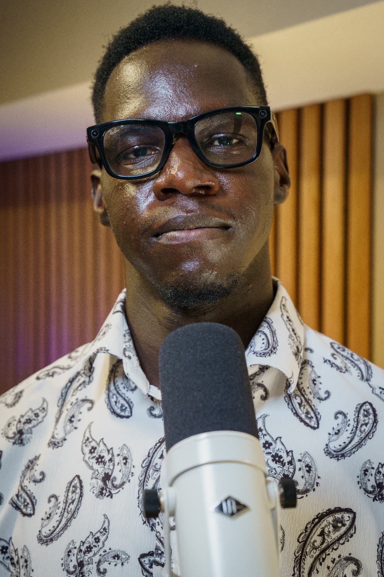 Peace Academy instructor behind a studio microphone during a lesson